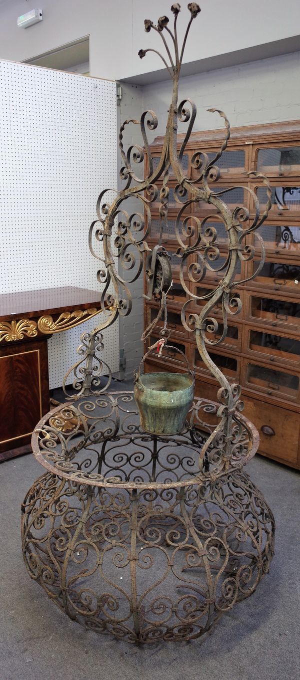 An early 20th century wrought iron onion shaped well head, 105cm wide x 215cm high.