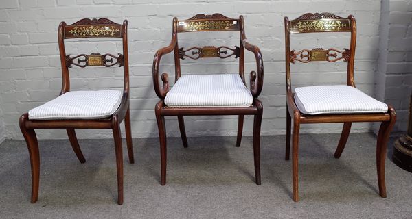 A Regency brass inlaid carver chair with tablet waist rail and sabre supports, together with two matching single chairs, (3).