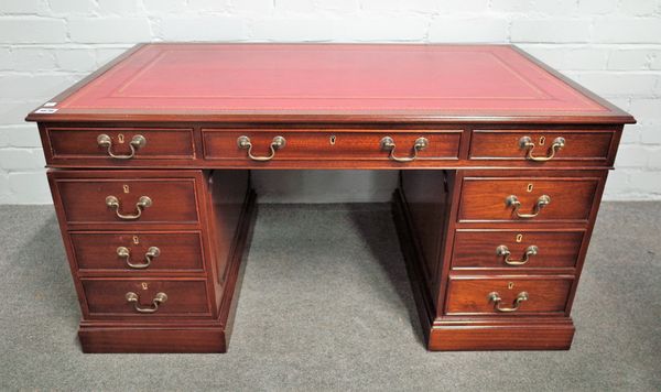 A diminutive mahogany nine drawer pedestal desk of 18th century style, 103cm wide x 61cm deep.