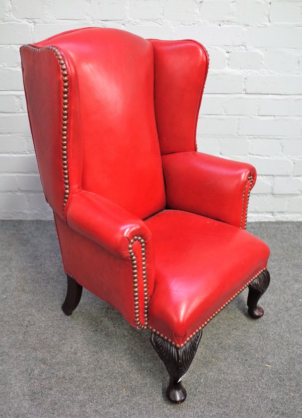 A diminutive rouge leather upholstered wingback armchair, on squat cabriole supports, 39cm wide x 72cm high.