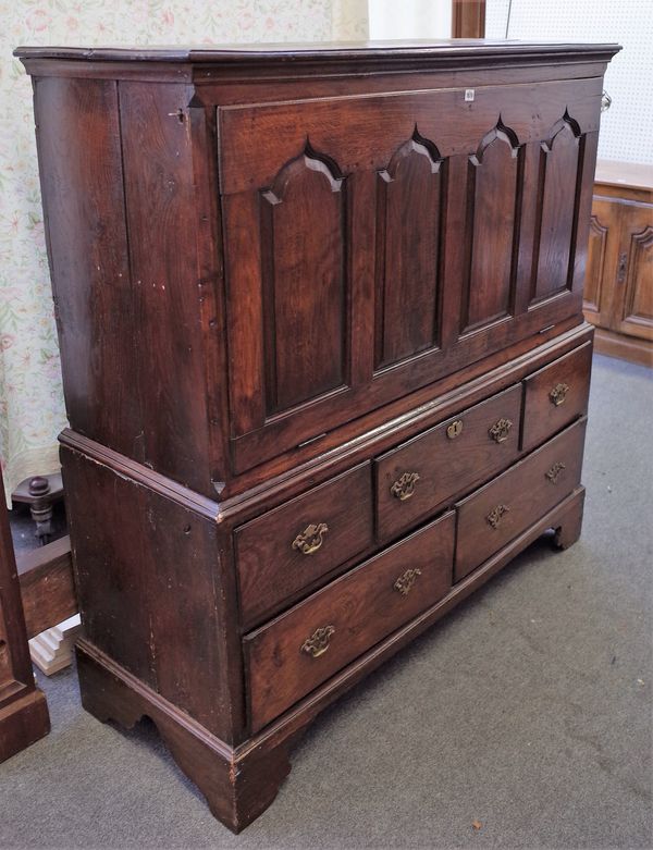 A George III oak mule chest with later adapted fall front panel over three short and two long drawers, 141cm wide x 148cm high.