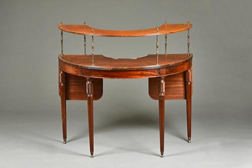 A George III mahogany drop flap demi-lune hunt table, with later superstructure on turned supports, 114cm wide x 108cm high.  Illustrated £15