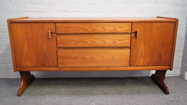 A mid-20th century teak sideboard with three central drawers, flanked by cupboards on trestle supports, 152cm wide x 77cm high.