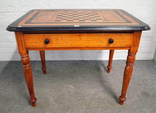 A 19th century Anglo-Indian ebony and satinwood games table with chess board inlaid top and single frieze drawer, on turned supports, 98cm wide x 75cm