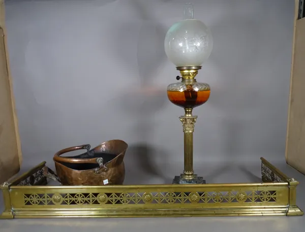 A Victorian oil lamp on brass fluted acanthus column and marble plinth base, 80cm high, a copper coal scuttle and a 19th century brass fender, 110cm w