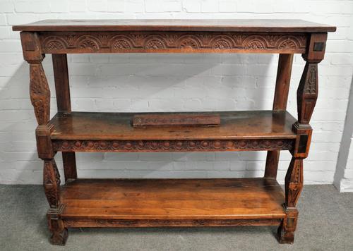 A 17th century and later carved oak three tier buffet on tapering square supports, 141cm wide x 120cm high.