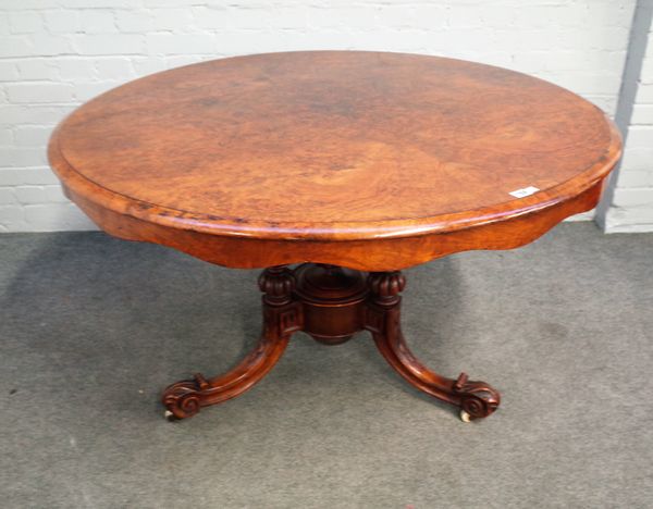 A Victorian figured walnut circular snap top centre table on carved tripod base, 121cm diameter x 73cm high.