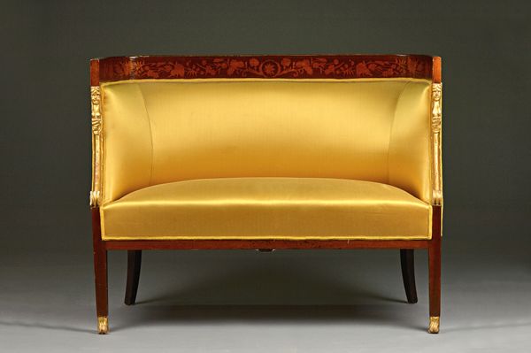 A late 19th century French inlaid mahogany parcel gilt three piece suite to comprise; a sofa 134cm wide x 102cm high, a pair of tub chairs, each with