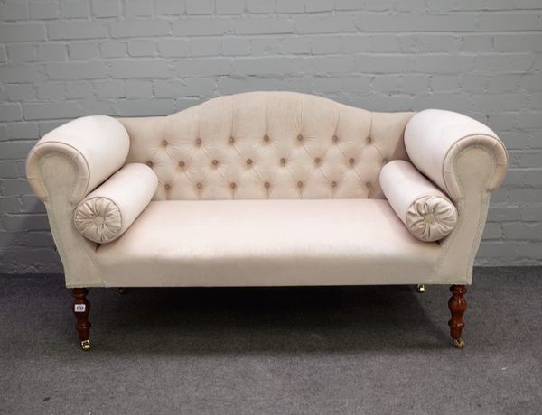 A Regency style small hump back sofa with roll over arms on turned supports, 140cm wide x 77cm high.