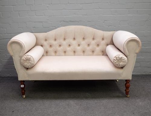 A Regency style small hump back sofa with roll over arms on turned supports, 140cm wide x 77cm high.