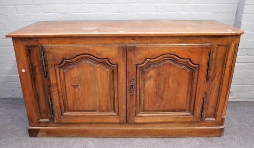A 19th century French oak dresser base with pair of arch panel doors, 161cm wide x 85cm high.