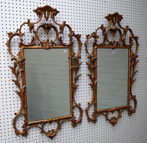 A pair of George III style gilt framed mirrors circa 1900, each with pagoda carved top above opposing 'C' scroll upper and lower frieze and acanthus c