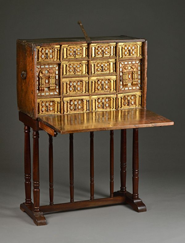 A 17th century Spanish walnut Vargueno, the iron bound fall front revealing a gilt and spiral turned bone interior with ten drawers and two cupboards