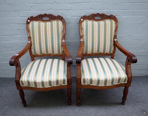 A pair of mid-19th century French mahogany open arm fauteuils on reeded baluster supports, 59cm wide x 94cm high (2).