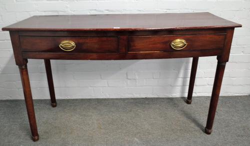 An early Victorian mahogany bowfront two drawer serving table, on turned supports, 136cm wide x 80cm high.