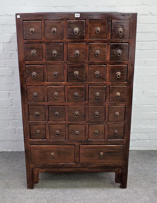 An early 20th century Chinese elm thirty two drawer apothecary chest on block feet, 82cm wide x 140cm high x 56cm deep.