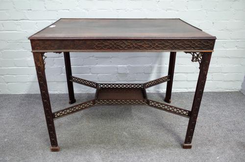 A George III style rectangular mahogany silver table, with extensive open and blind fret decoration on canted square supports, 86cm wide x 71cm high.
