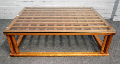 A Japanese rectangular glass top coffee table with soft wood lattice top on turned supports, 82cm wide x 116cm high.
