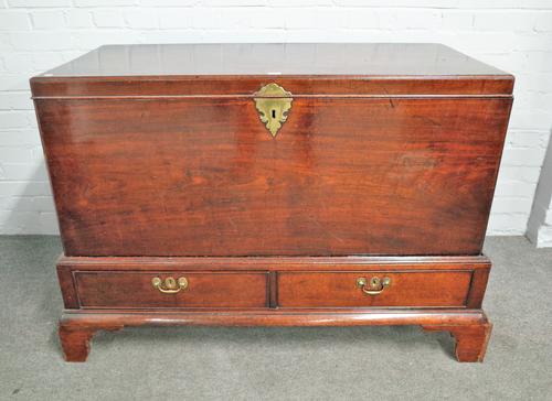 A George II mahogany lift top trunk, in the Irish manner, on a two drawer stand with bracket feet, 130cm wide x 87cm high.