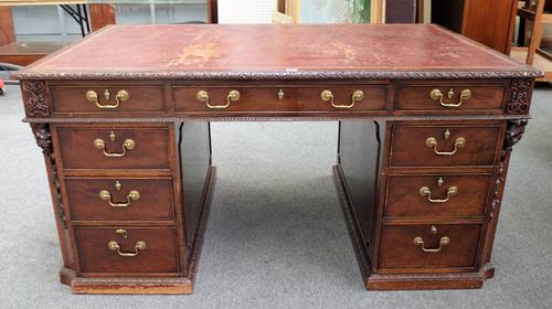 An 18th century style carved mahogany pedestal desk with nine drawers about the knee and opposing cupboards, 157cm wide x 97cm deep. Provenance; Sir H