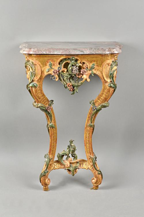 A 19th century Italian console table, the serpentine marble top over a polychrome painted floral chased gilt base, 57cm wide x 80cm high. Illustrated