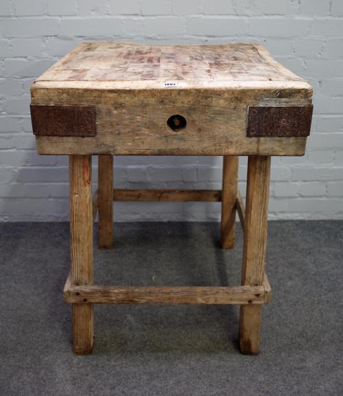 A square metal bound butchers block on pine base, 62cm wide x 82cm high.