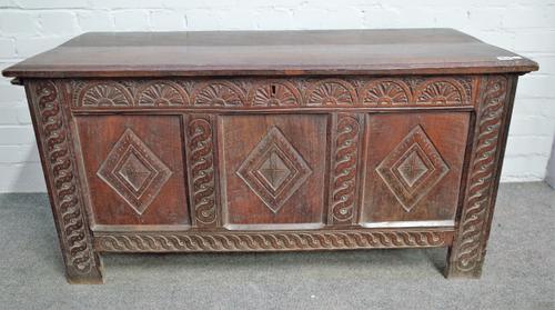 A 17th century and later oak coffer with carved triple panel front, 120cm wide x 60cm high.