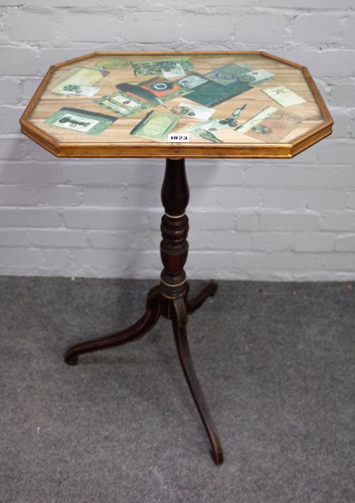 An early 19th century occasional table with trompe l'oeil top on a faux rosewood tripod base, 48cm wide x 78cm high.