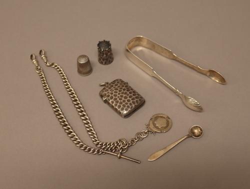 Silver, comprising; a rectangular vesta case with simulated reptile skin decoration, Birmingham 1900, a gentleman's graduated curb link watch Albert c