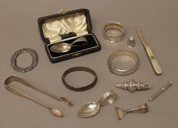 Silver and silver mounted wares, comprising; a pair of sugar tongs, London 1858, a child's spoon, Birmingham 1934, with a case, a child's pusher and s