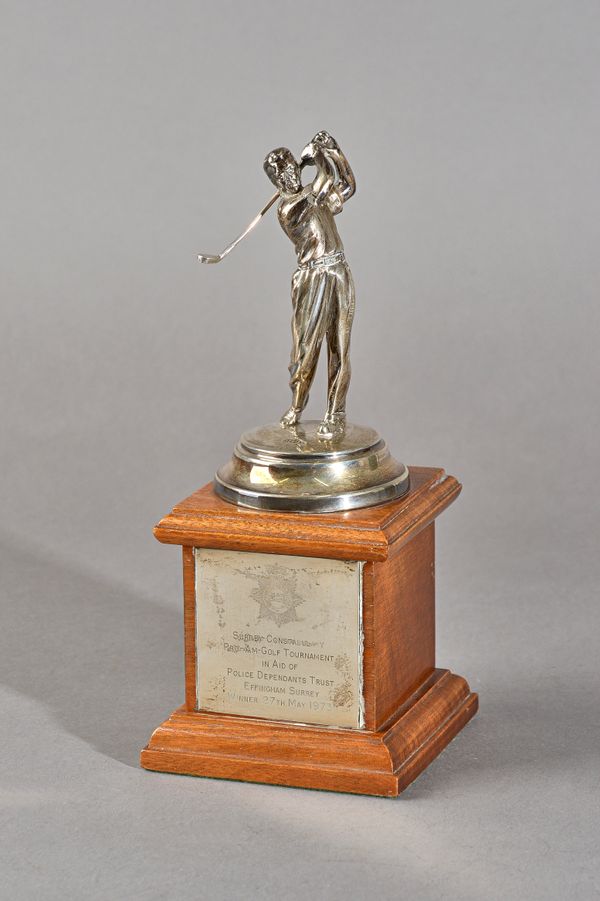 A silver golfing trophy, modelled as the standing figure of a golfer, Birmingham 1972, (his golf club detached, but present, fitted to a wooden stand,