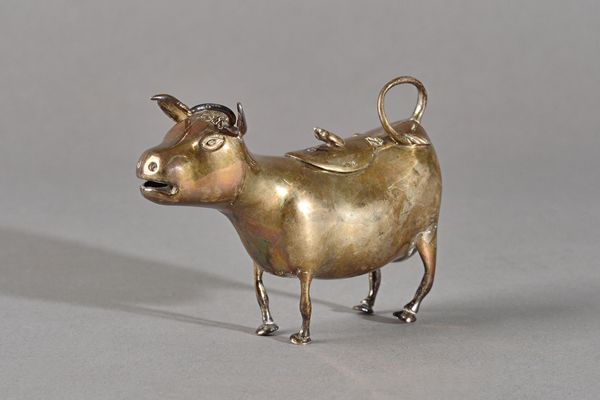 A Victorian silver cow creamer, the standing model of a cow with a hinged lid and fly thumbpiece, import mark London 1892, weight  172 gms. Illustrate