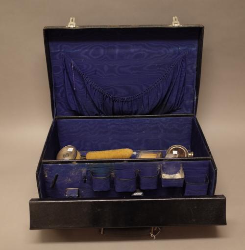 A silver mounted composite part toilet set, comprising; a hand mirror, a hairbrush, a clothes brush, a comb and five various toilet bottles and jars,