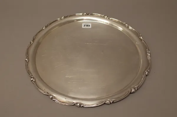 An Egyptian shaped circular salver, decorated with buds at intervals to the shaped rim, diamter 37.5cm, weight 1280 gms.