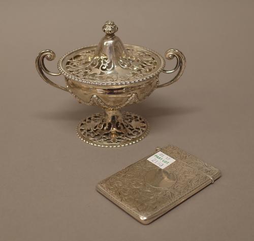 Silver, comprising; a twin handled pot pouri bowl and cover, with pierced decoration to the foot and to the cover, otherwise decorated with pendant sw