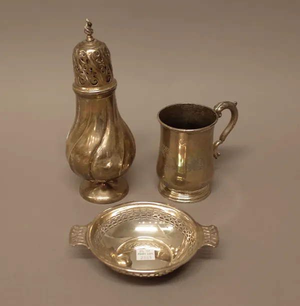 Silver, comprising; a sugar caster, of spiral fluted baluster form, Birmingham 1915, a christening mug, with a scrolling handle, Birmingham 1927 and a