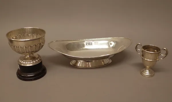 Silver, comprising; a boat shaped dish, Chester 1926 and a twin handled trophy cup, Birmingham 1937, combined weight 468gms, also a silver trophy bowl