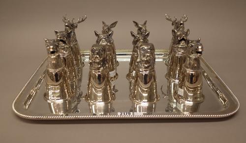 Plated wares, comprising; two similar rectangular trays, each decorated with a ropetwist border, lengths 53cm and 43cm and a set of twelve stirrup cup