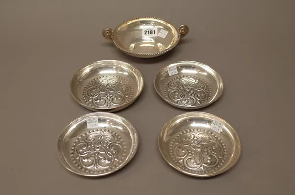 Foreign wares, comprising; a Greek twin handled circular bowl, having a cable border and four circular dishes, with similarly scroll embossed decorati