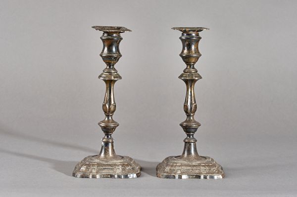 A pair of silver table candlesticks, each having a knopped stem and raised on a shaped square base, in the 18th century taste, (loaded), Sheffield 191