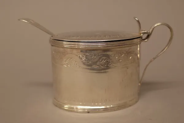 A George III silver mustard pot, of oval form with engraved decoration within reeded rims, London 1799, with a blue glass liner and a silver mustard s