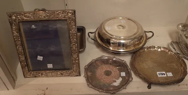 A silver salver of shaped circular form, with later floral, foliate and scroll embossed decoration within a pie-crust rim, raised on three feet, Londo