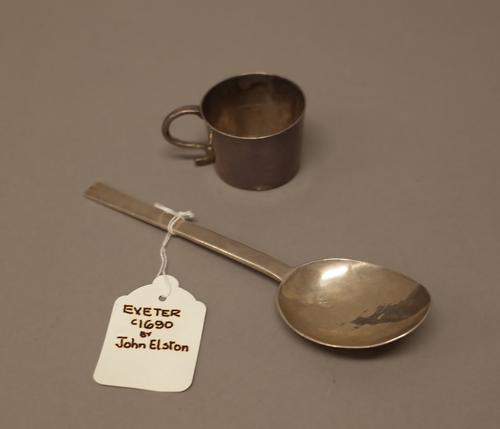 A slip top style spoon, possibly Exeter late 17th century, length 16.5cm and a small mug, having a scrolling handle, engraved with initials I*S and S