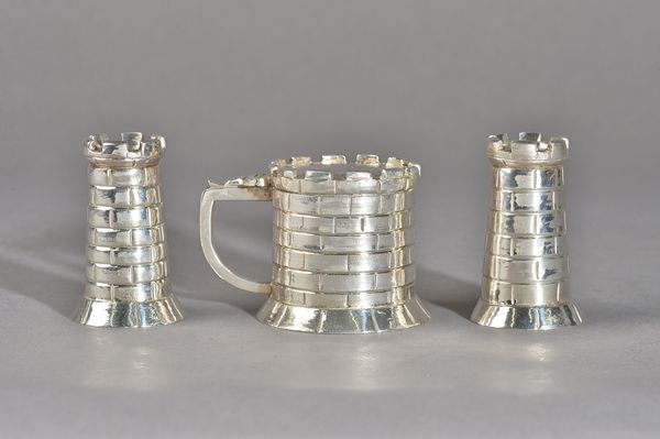 A plated novelty three piece condiment set, comprising; a mustard pot and a pair of pepperettes, each designed as a castle, the mustard pot with a blu