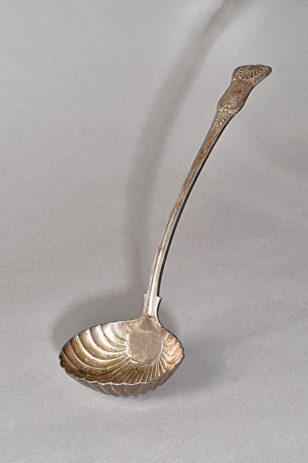 A William IV silver Kings pattern soup ladle, the oval bowl with scallop fluted decoration, London 1835, weight 330 gms. 1564