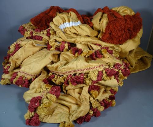 Textile furnishings for a four poster bed, plain gold with red and gold pom-pom edges.    BAY 1  50