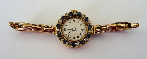 An 18ct gold cased, sapphire and diamond set lady's dress wristwatch, the silvered dial with black Arabic numerals, the bezel set with a surround of a