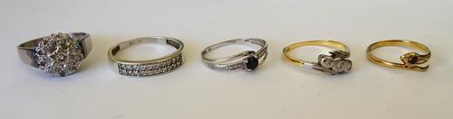 An 18ct white gold and diamond cluster ring, mounted with the principle circular cut diamond at the centre, a gold and platinum diamond set three ston