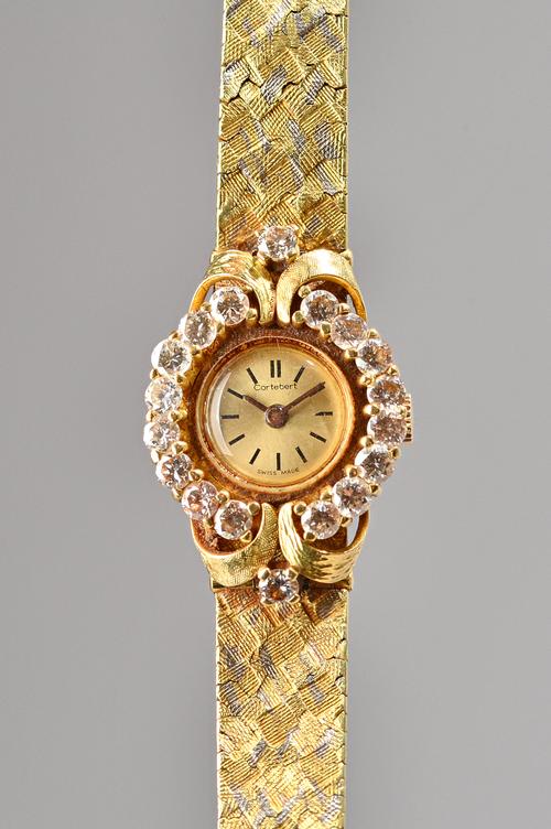 A Cortebert 18ct gold and diamond set lady's dress wristwatch, the signed circular gilt dial with black baton numerals, the bezel and bracelet termina
