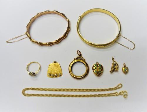 A late Victorian 9ct gold oval hinged bangle, in a simulated bamboo design, on a snap clasp, Birmingham 1896, a 9ct gold oval hinged bangle, the front